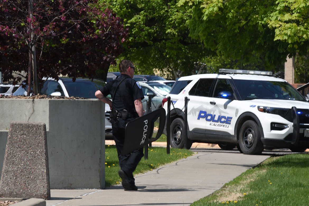 Kalispell Police officers depart the Flathead County Justice Center after responding to a man wielding a knife on the building's third floor, which hosts the Flathead County District Court. (Derrick Perkins/Daily Inter Lake)