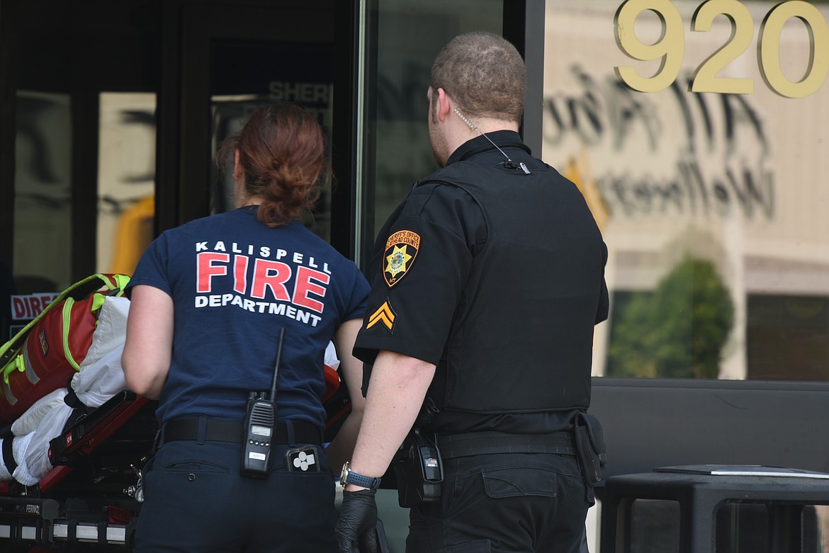 First responders enter the lobby of the Flathead County Justice Center following reports of a man wielding a knife on the building's third floor. The man was later taken for medical and mental health evaluations, said Sheriff Brian Heino. (Derrick Perkins/Daily Inter Lake)