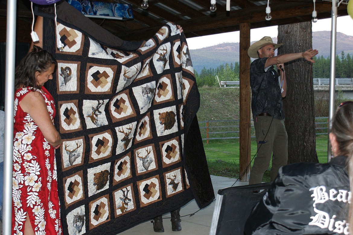 A Troy woman made and donated a quilt to the Yaak WINGS fundraising event on Saturday, May 13. It was in honor of her son and others who have passed away from cancer. Auctioneer Jason Fosgate secured a winning bid of $1,500. (Photo courtesy Larry Miller)