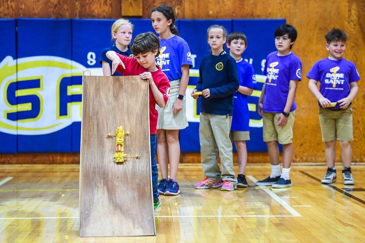 St. Matthew's School first-grader Max Schipper releases his pasta mobile, a vehicle constructed entirely of pasta and glue, down a ramp in hopes that it will stay intact as part of teacher Susie Rainwater's K-5 science class on Wednesday, May 17. (Casey Kreider/Daily Inter Lake)