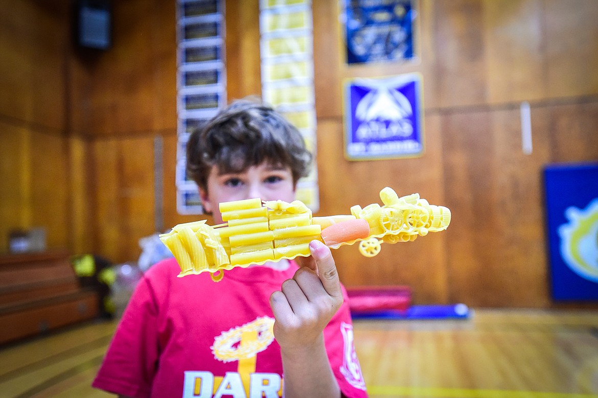 St. Matthew's School first-grader Max Schipper shows his pasta mobile, a vehicle constructed entirely of pasta and glue, after a run down a ramp as part of teacher Susie Rainwater's K-5 science class on Wednesday, May 17. (Casey Kreider/Daily Inter Lake)