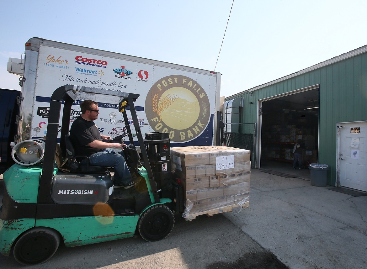 Post Falls Food Bank warehouse employee Steven Magnuson moves a big pallet of cheese Wednesday, May 17 after the nonprofit received about 24,000 pounds of food donated by members of the Church of Latter-day Saints.