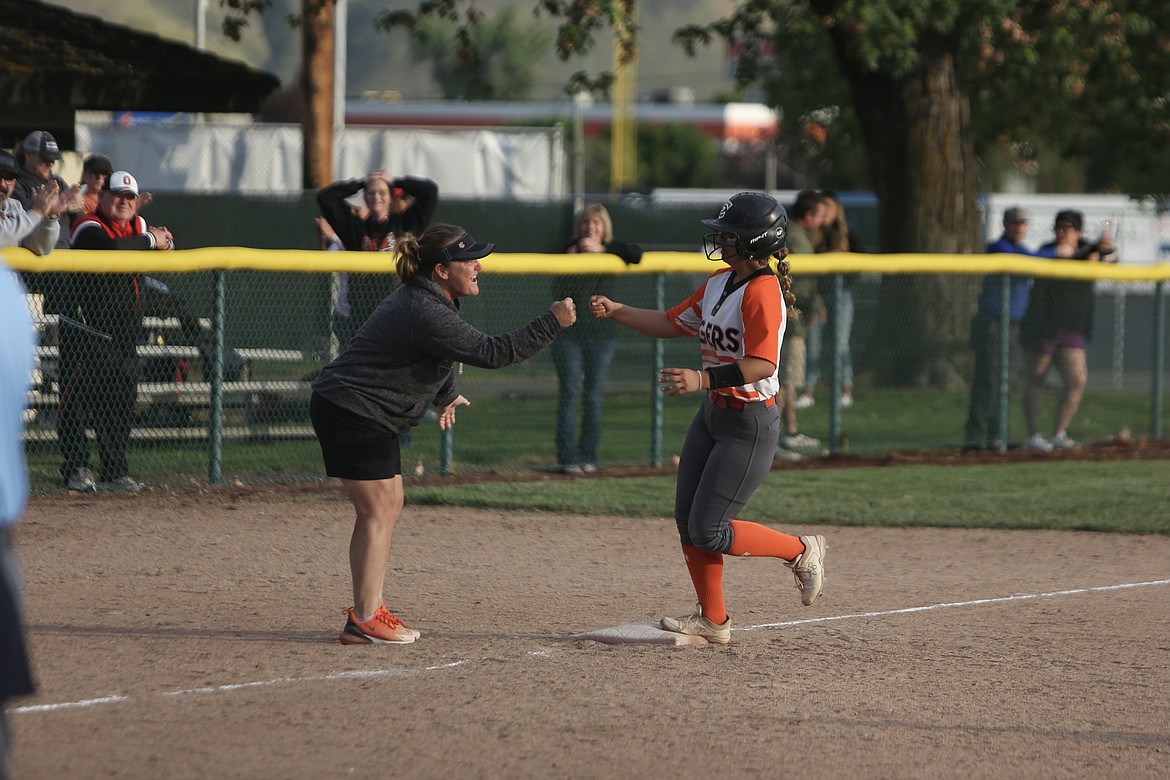 Ephrata sophomore Jaemyson Durfee, right, fist-bumps Head Coach Heather Wood, left, as Durfee rounds third base after tying the game in the bottom of the seven inning with a two-run home run.