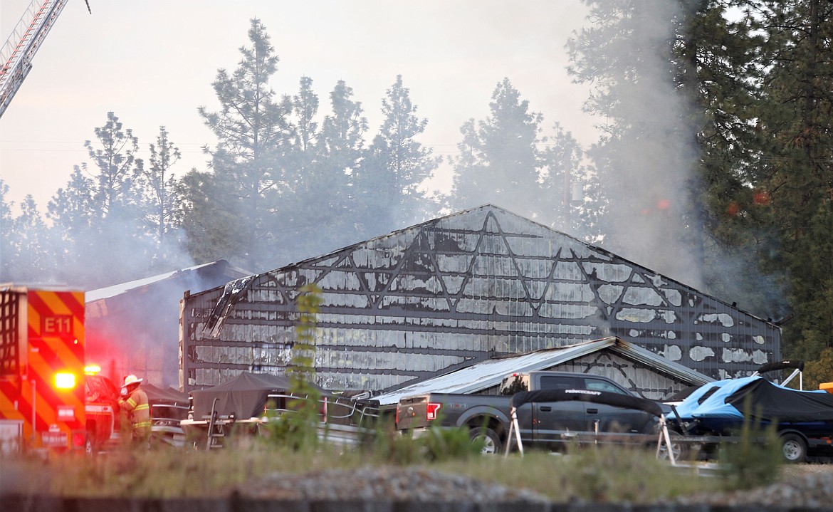 Smoke rises from a building that caught fire Wednesday night just off Seltice Way and Huetter Road. Mitchell Copstead, division chief with Kootenai County Fire and Rescue, said firefighters arrived at 7:08 p.m. and prevented the fire from spreading to surrounding trees and structures. The two-alarm blaze caused extensive damage to the structure, which had three tenants and housed several bays and an office, before it was contained, Copstead said. There was no one in the building when the fire started, but two people were evaluated onsite for smoke inhalation and declined medical transport. Coeur d’Alene and Northern Lakes firefighters also responded to the fire that was initially reported by passersby on Interstate 90.  The cause of the fire remains under investigation.