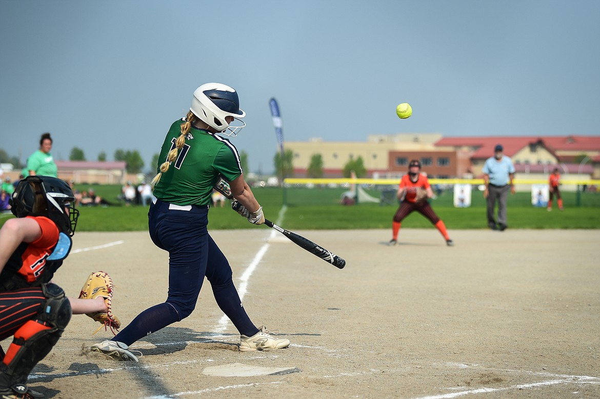 Glacier's Emma Cooke (11) connects on a three-run home run in the first inning against Flathead at Glacier High School on Thursday, May 18. (Casey Kreider/Daily Inter Lake)