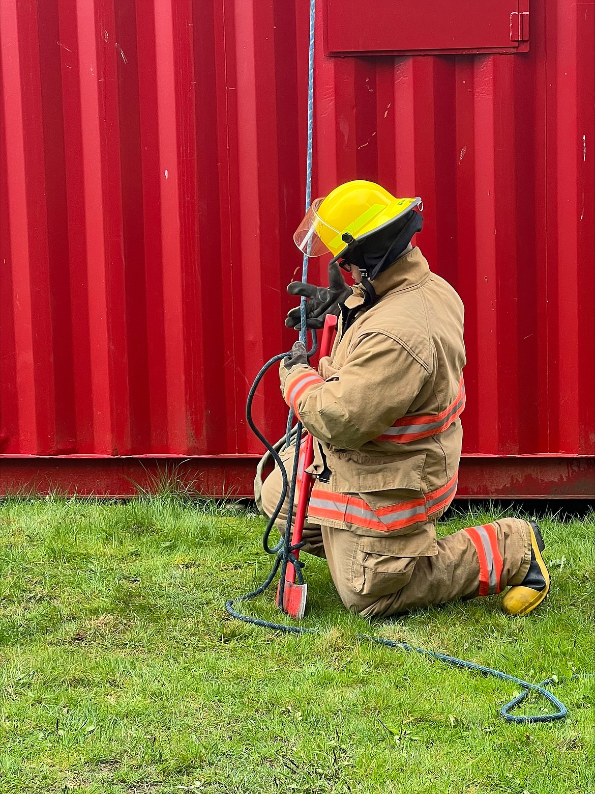 Doing detailed work in full fire gear, like attaching to a line, is one of the tests at SkillsUSA state competition. Students from Quincy High School participate in the competition as part of their path on the way to becoming firefighters.