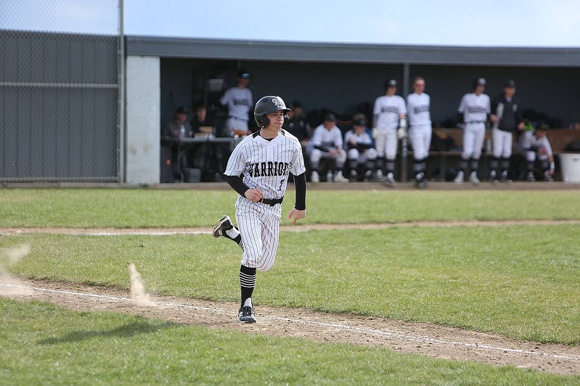 ACH junior Everett Wood runs to first base after making contact with a pitch against Columbia (Hunters) on April 18.