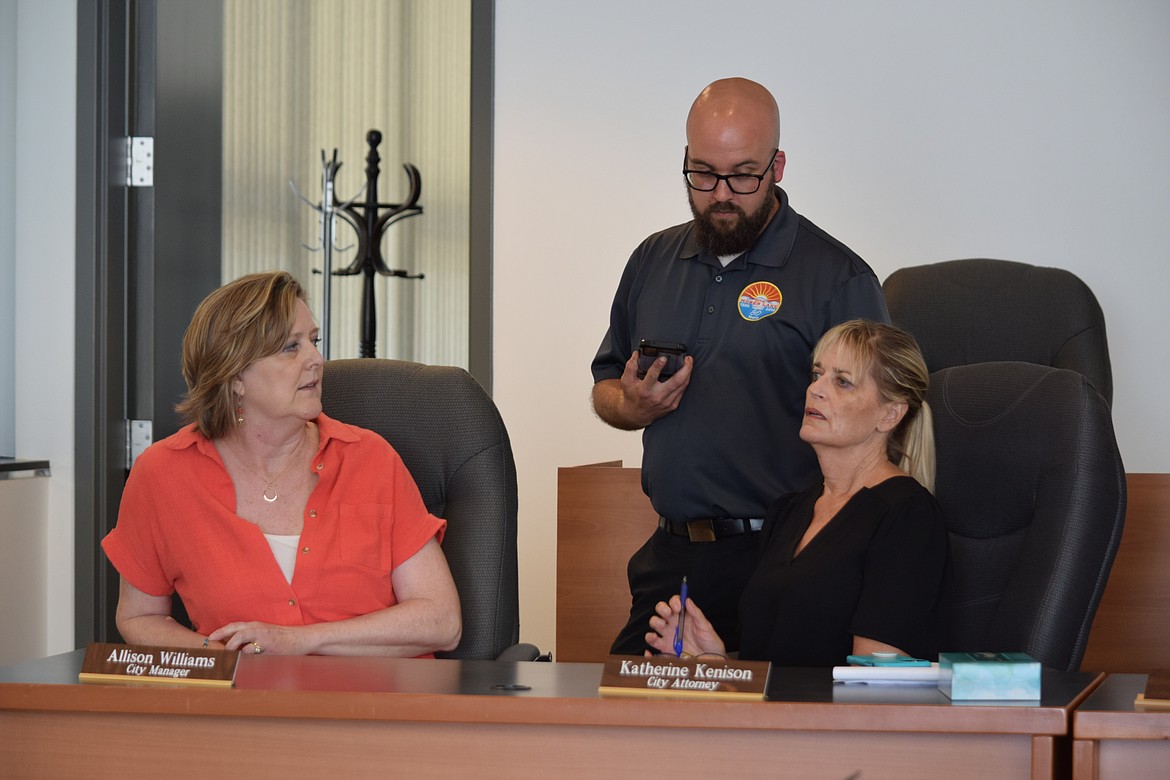 Moses Lake City Manager Allison Williams, Mayor Don Myers, and City Attorney Katherine Kennison talk prior to Friday’s special Moses Lake city council meeting where Williams submitted, and the city council accepted, her resignation.