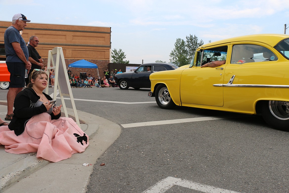Makayla Davis-Barrus of Thompson Falls, Mont., finds a spot at the corner of First and Church to watch the classic cars make their way through downtown Sandpoint during the Lost in the '50s classic car parade.