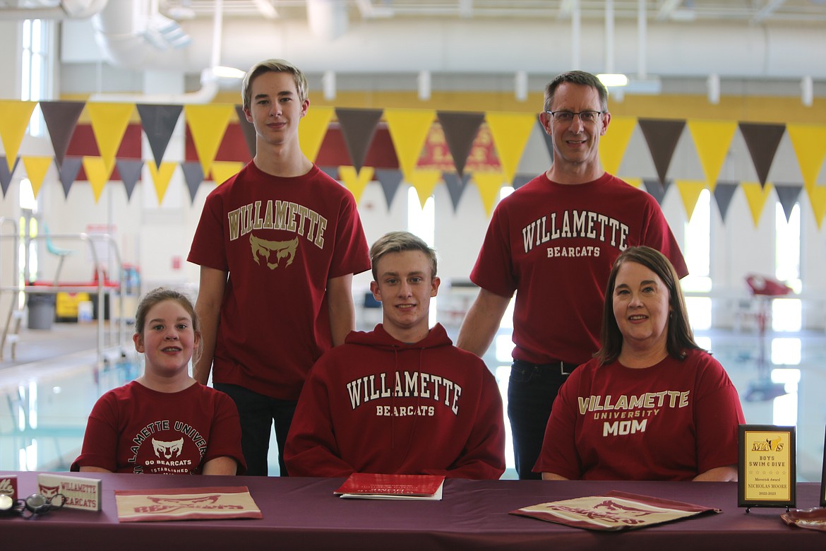 Moses Lake senior Nicholas Moore, center front row, signed on to swim at Willamette University in Salem, Oregon on Friday.