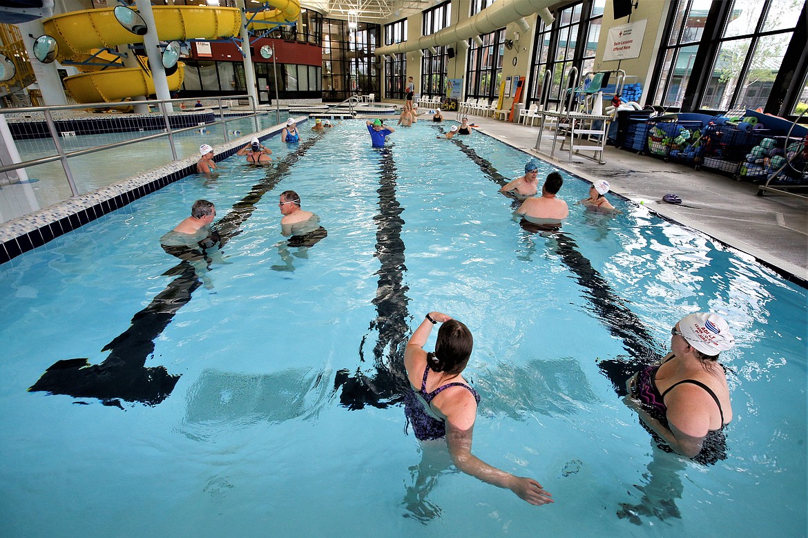 Instructors and students take to the pool at the Kroc Center for adult swim lessons Wednesday.