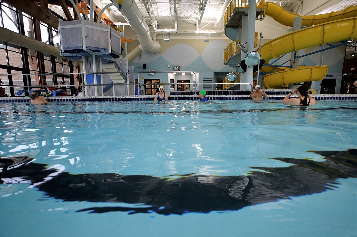 Instructors and swimmers in the pool for adult swim lessons at the Kroc Center spend time in the pool Wednesday.