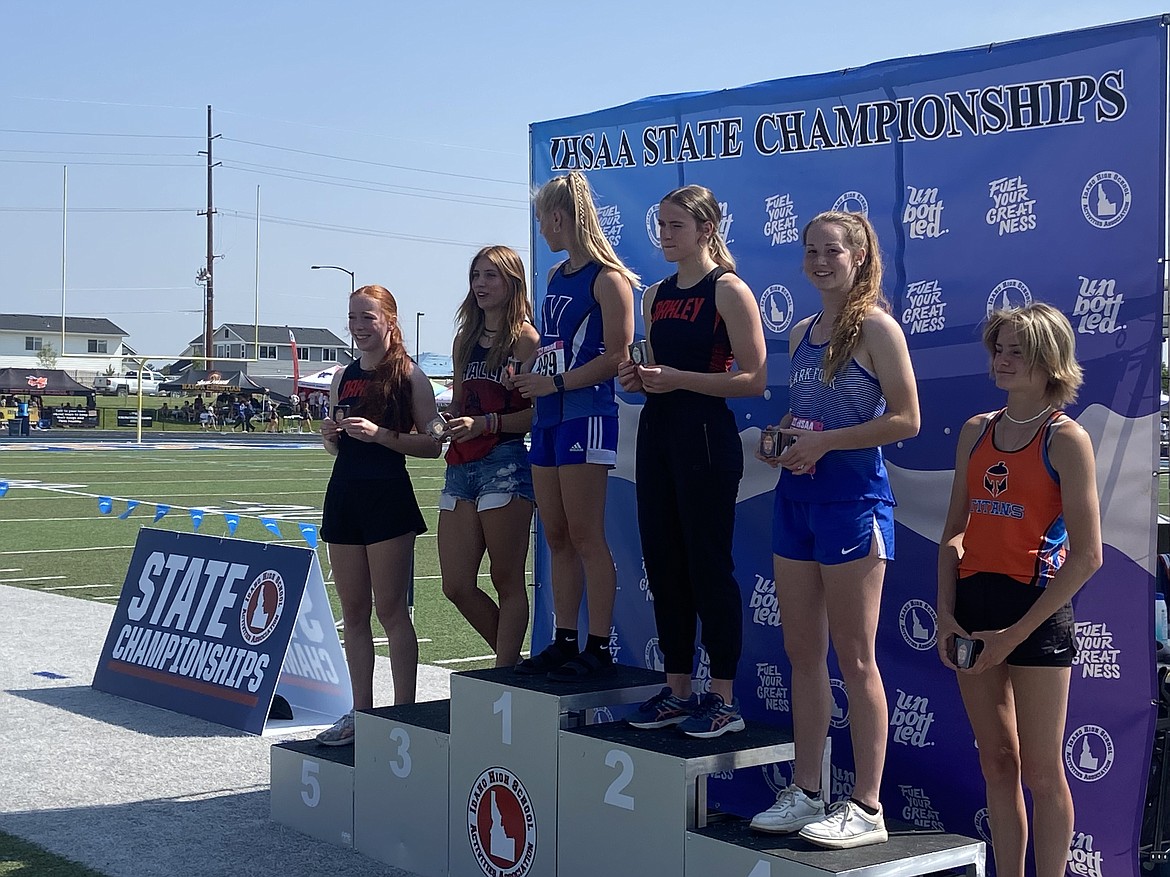 Savannah Weymouth stands on the podium to receive her fourth-place medal in the pole vault on Saturday.