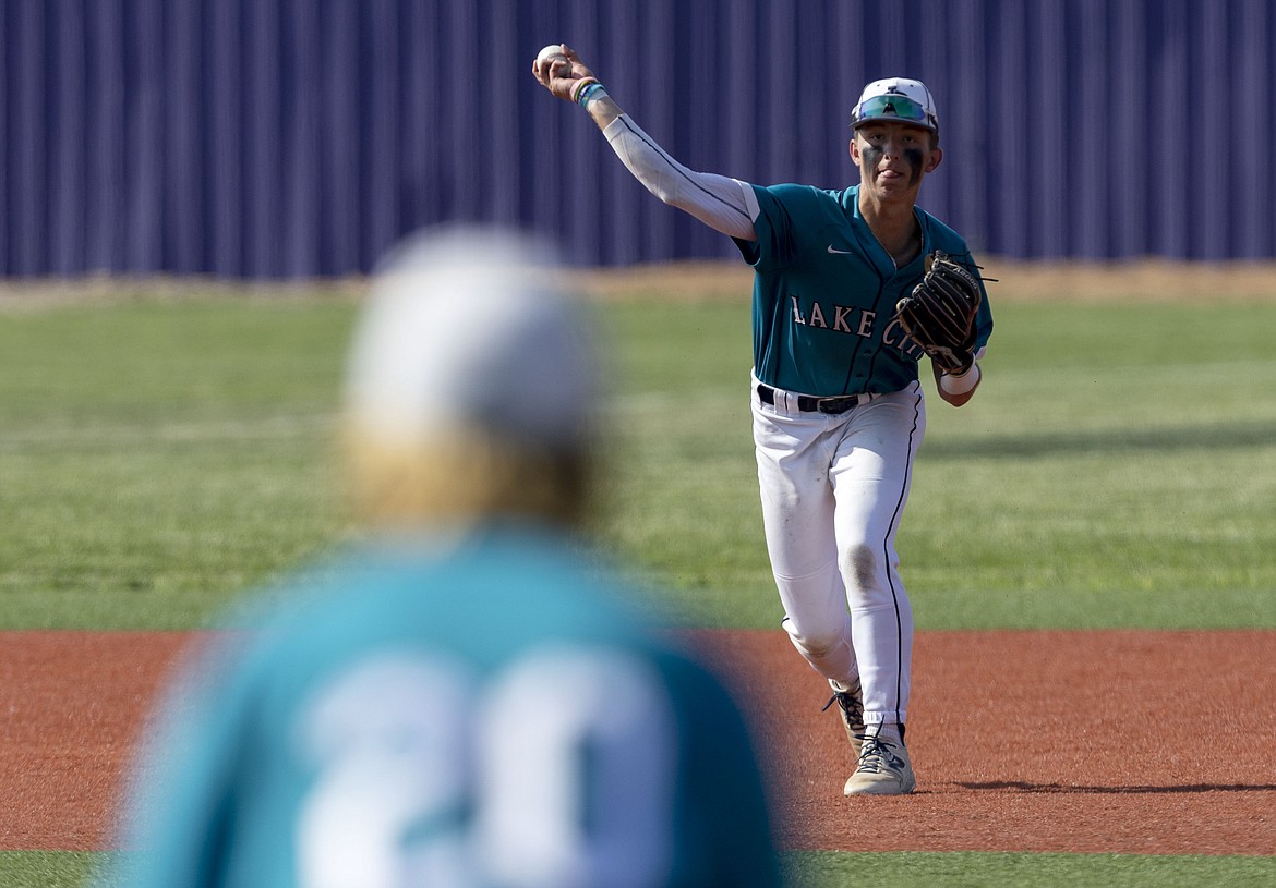 DARIN OSWALD/The Idaho Statesman
Lake City shortstop Joe DuCoeur throws to first baseman Cole Stoddard (20) for the out during Saturday's state 5A baseball championship game vs. Owyhee at the College of Idaho's Wolfe Field in Caldwell.