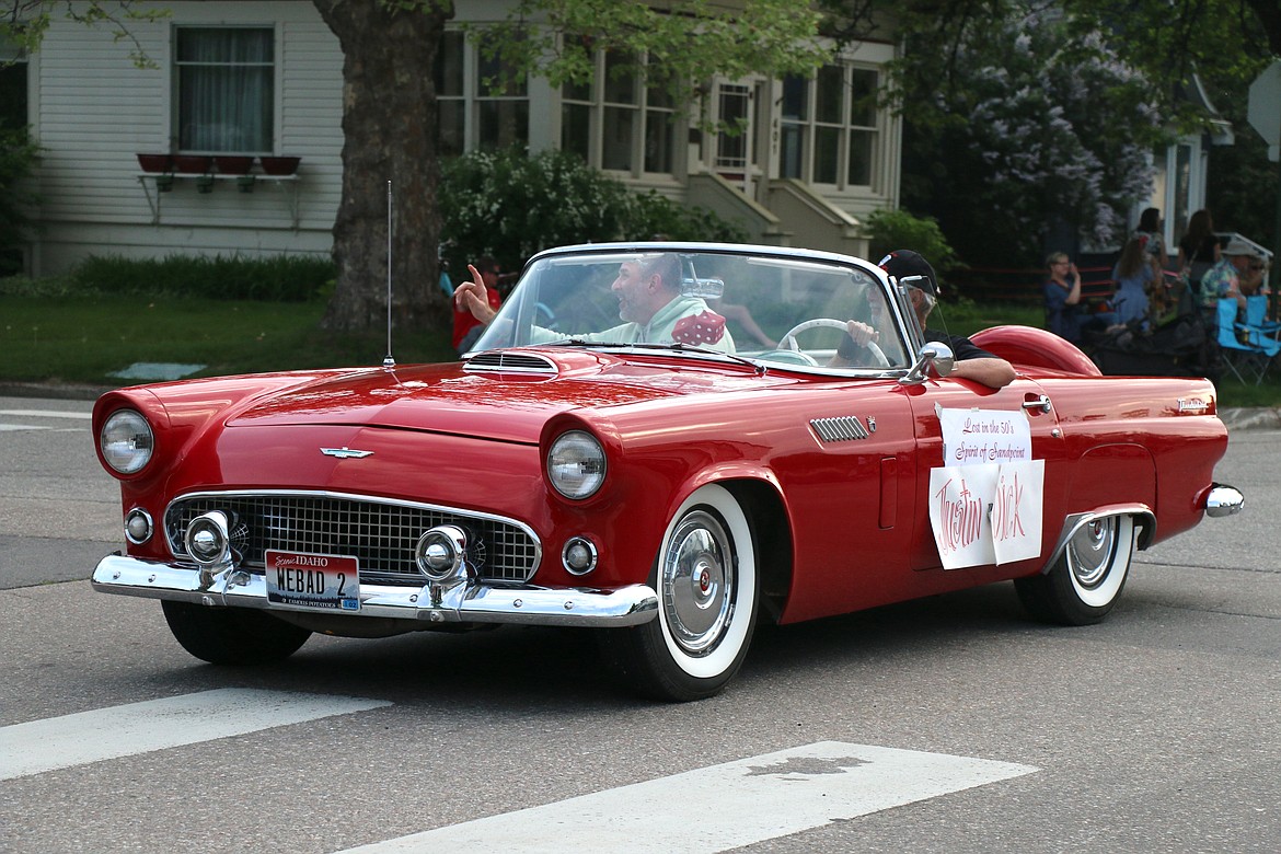 Justin Dick, dubbed the Spirit of Sandpoint by Lost in the '50s organizers, waves to the crowds as the cars make their way down Church Street during the classic car parade on Friday night.