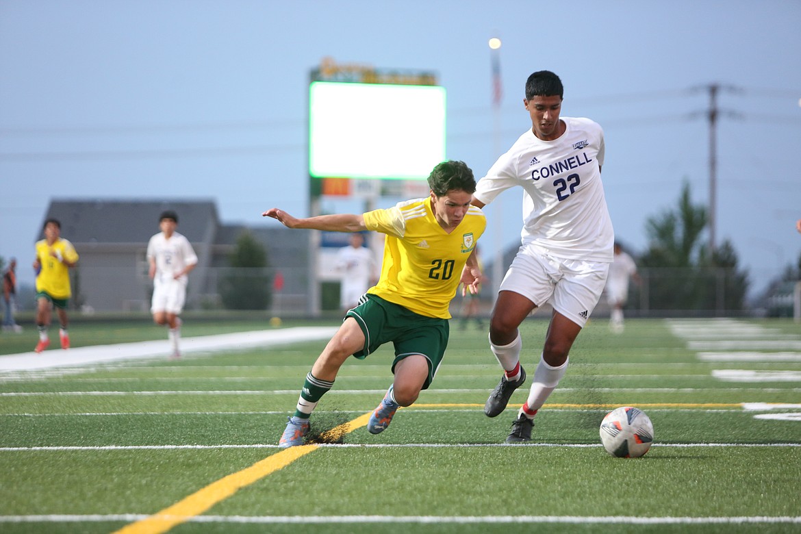 Quincy junior Efrain Pena looks to get past a Connell defender near the Eagles’ net in the second half of Friday’s 3-2 loss.