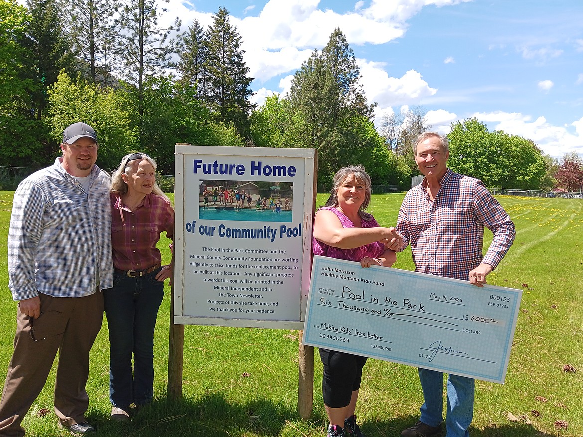 John Morrison, far right, presented a donation to Cheryl Crabb, Pool in the Park Committee Chair, where the pool will be built in the Eva Horning Park. Drew Hanson and Liz Gupton, both with the Mineral County Community Foundation were on hand to thank Morrison as this project is under the MCCF umbrella. (Monte Turner/Mineral Independent)