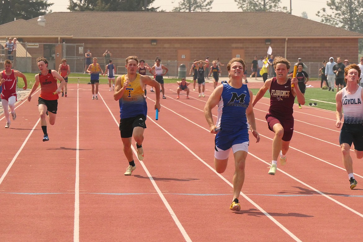 Thompson Falls senior Breck Ferris (Blue and gold jersey) runs the anchor leg of the Blue Hawks 4X100 relay team which finished fourth at this past weekend's Western Divisional track and field meet in Missoula. (Chuck Bandel/VP-MI)