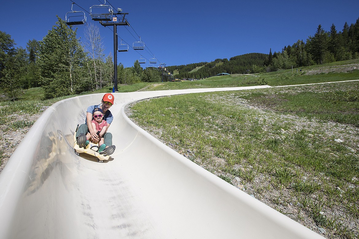 Visitors take a ride on the Alpine Slide at Whitefish Mountain Resort. (Photo by GlacierWorld.com)