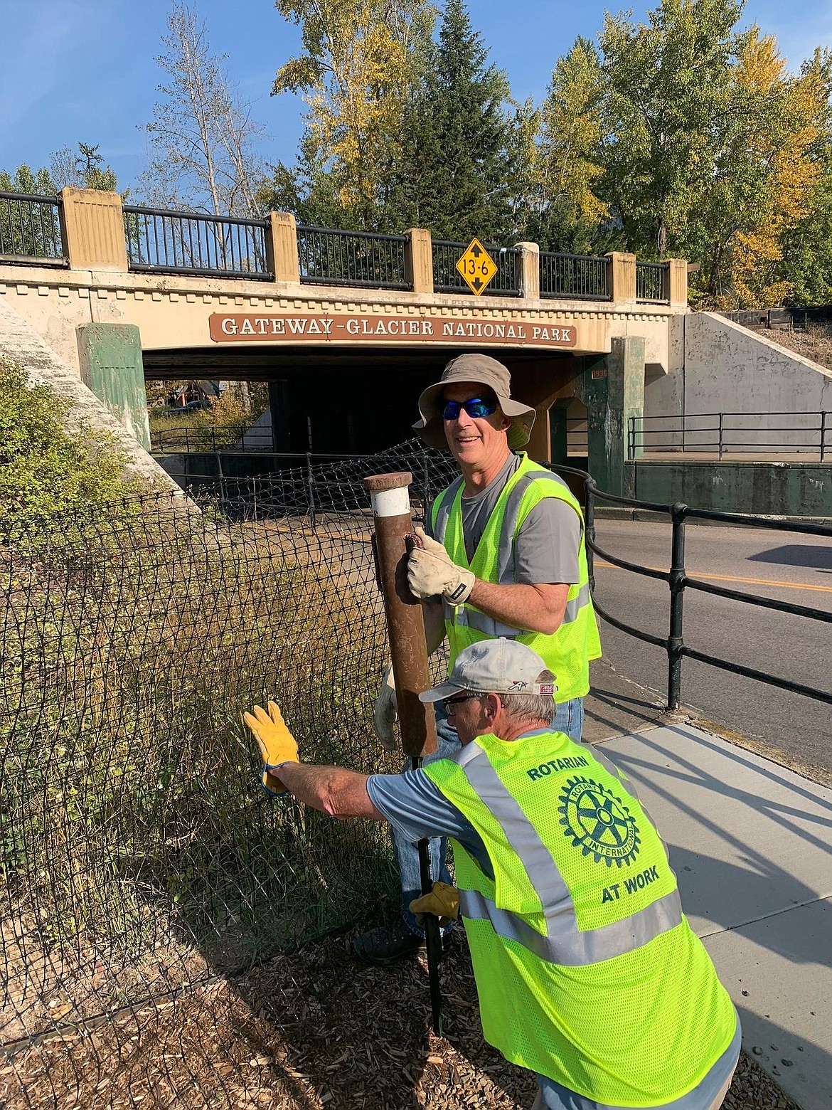 Volunteers with the Kalispell Daybreak Rotary Club help install snow fencing during the fall of 2022, as part of the West Glacier Historic Gateway Project. (photo provided)