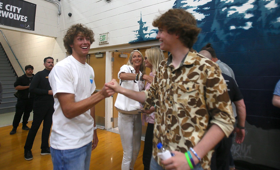 Coeur d'Alene High School senior Alexander Nipp, left, and Lake City High School junior Luke Sharon congratulate each other Monday after a successful mental health awareness series with Olympic swimmer Michael Phelps.