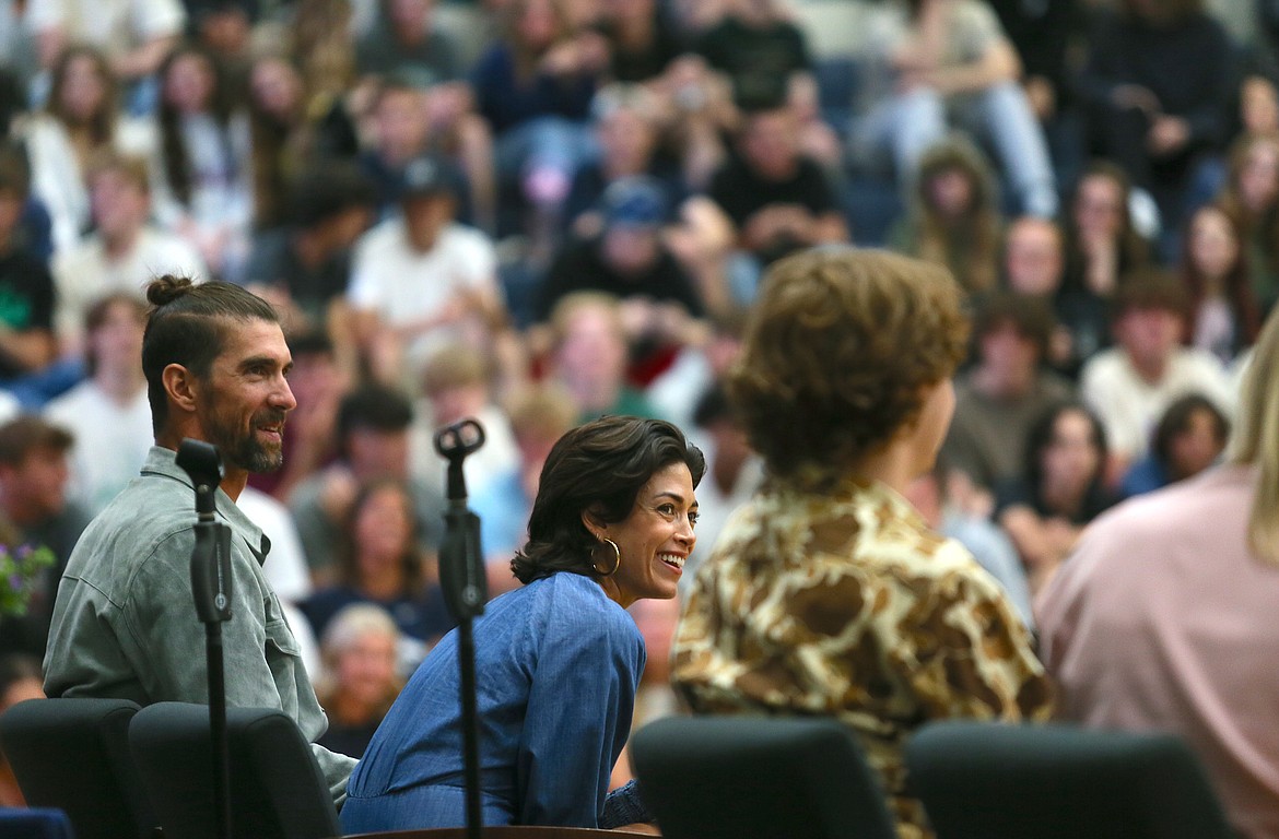 Michael Phelps, left, and wife Nicole Phelps participate in a panel about mental health Monday at Lake City High School.