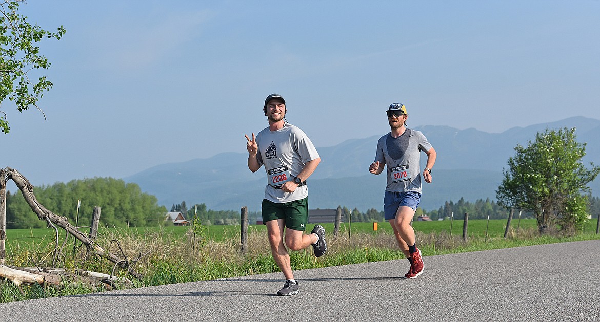 Runners Joe Wilkes and Todd Davidson finish the fourth mile of the half marathon on Saturday. (Julie Engler/Whitefish Pilot)