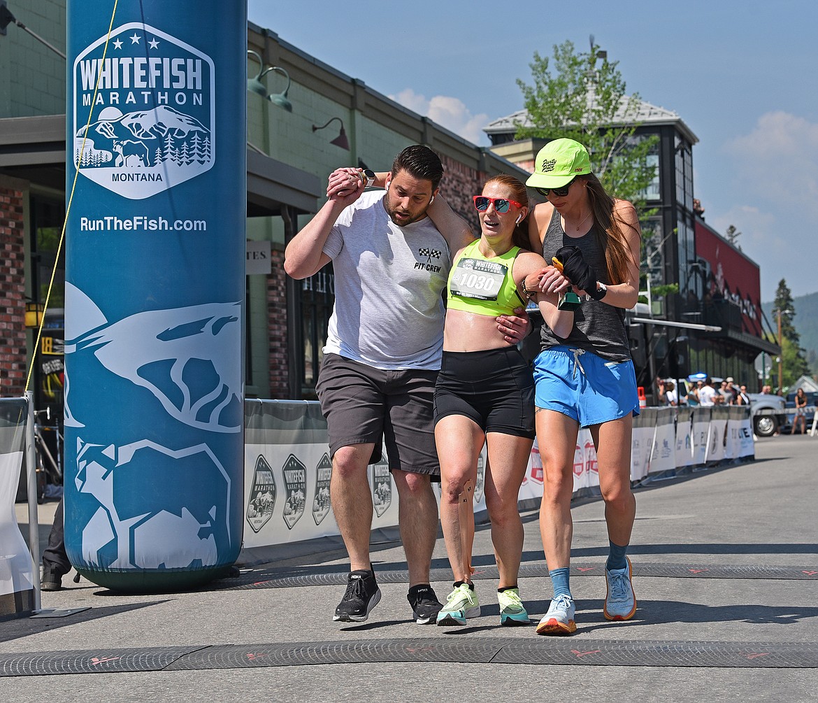 Robin Bewley gets a bit of help to cross the finish line as the second place woman in the Whitefish Marathon. (Julie Engler/Whitefish Pilot)