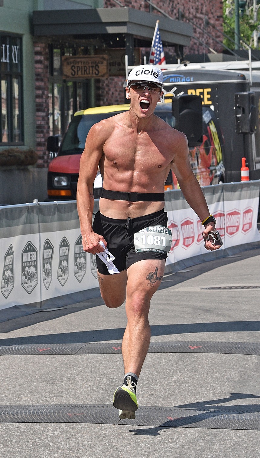 Nathan Peterson of Whitefish roars while crossing the finish line of the marathon. (Julie Engler/Whitefish Pilot)