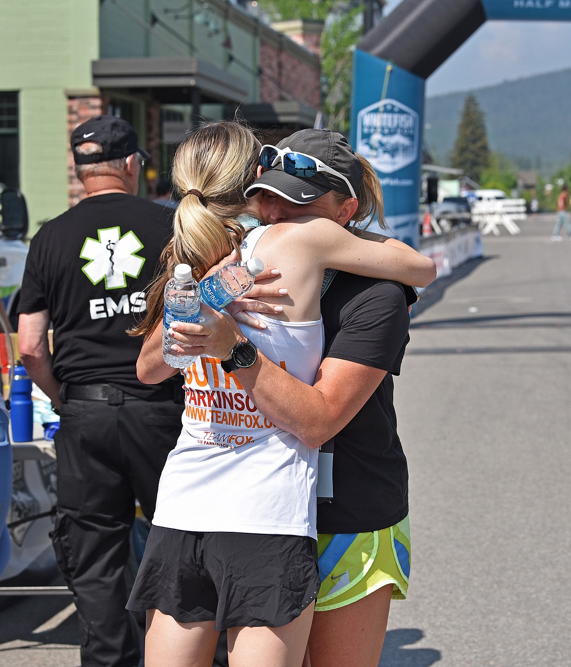 A postrace celebration hug at the finish line of the Whitefish Marathon. (Julie Engler/Whitefish Pilot)
