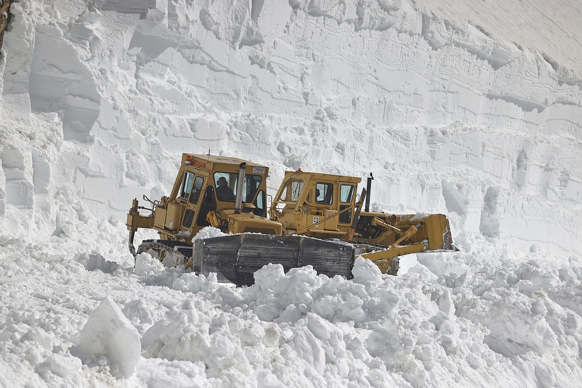 Tractors push snow off the Going-to-the-Sun Road at the Big Drift Tuesday. (JP Edge photo)
