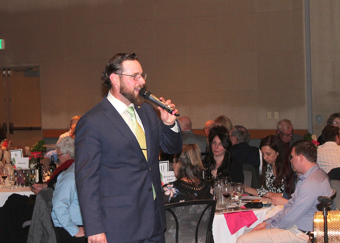 Auctioneer Jacob Barth takes bids at the Cellarbration! live auction Saturday. Barth also serves as chairman of the Big Bend Community College Foundation.