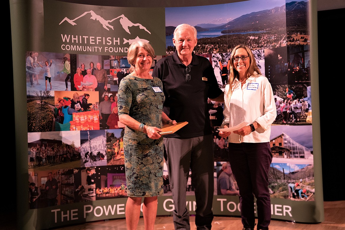 Mike Jenson, middle, presents the Founders Leadership Award to Carol Bibler, left, and Jen Guse, right, accepts the accompanying $2,500 grant to Flathead Land Trust during the Whitefish Community Foundation annual Community Grant Awards Celebration on May 18. (Courtesy photo)