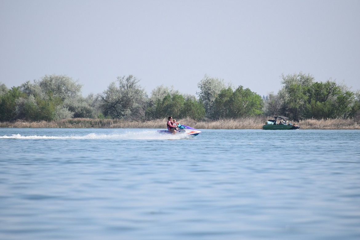 A personal watercraft zips across Moses Lake on a recent Saturday. A new law sponsored by Rep. Tom Dent, R-Moses Lake, and recently signed by Gov. Jay Inslee, clarifies the legal ability of the Moses Lake Irrigation District to levy assessments on property owners to maintain the quality of the lake for recreation.