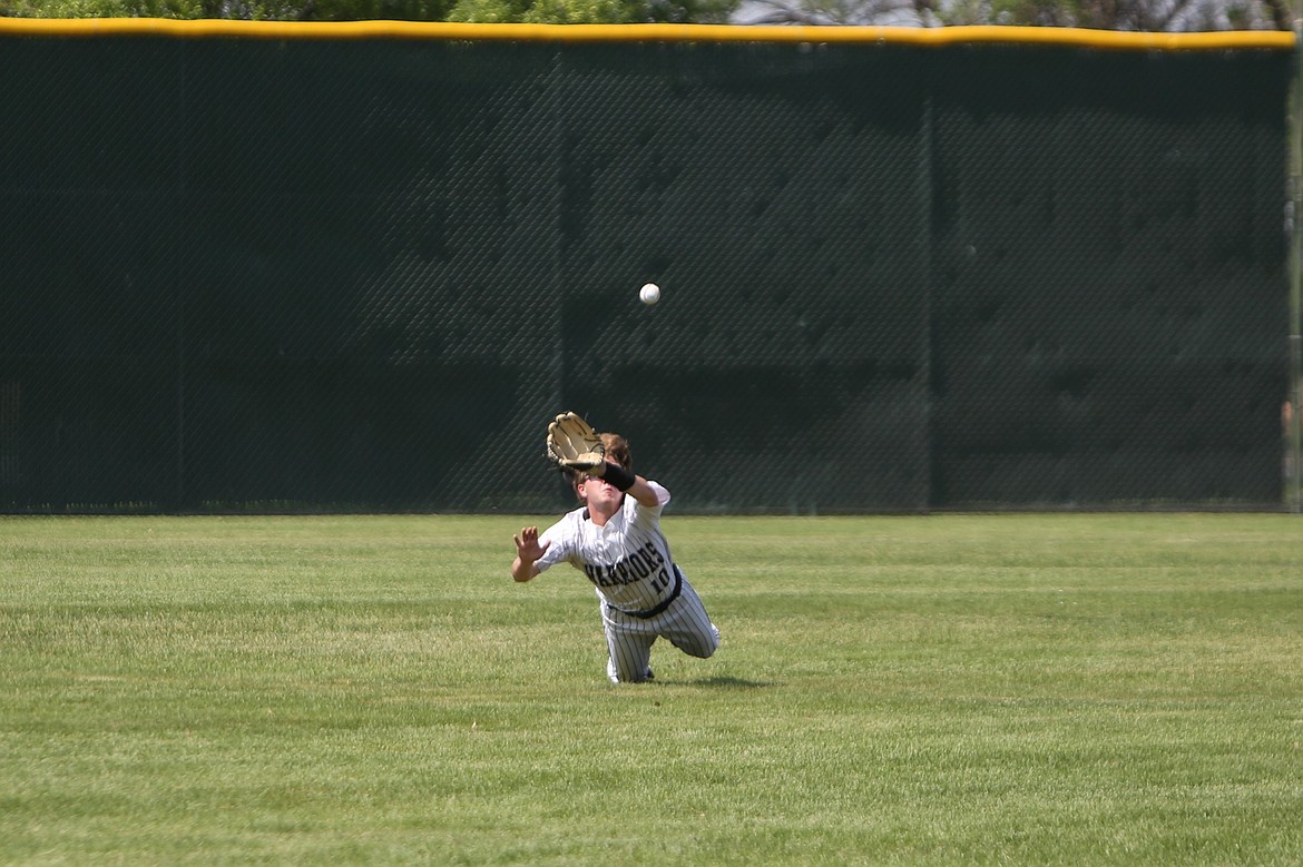 ACH junior Jaxon Baergen dives toward a fly ball in the outfield during the top of the fourth inning against Naselle.