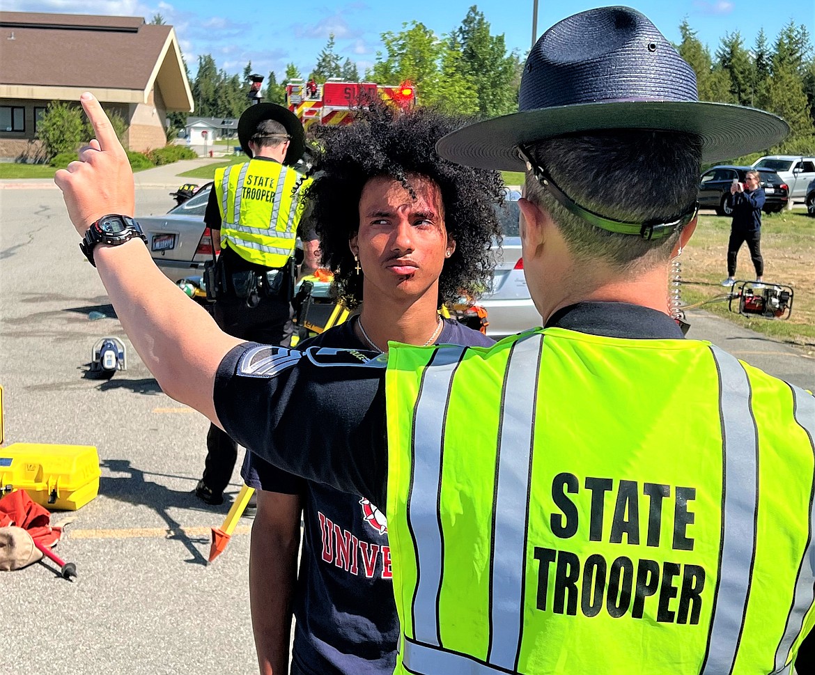 An Idaho State Police trooper gives a field sobriety test during a DUI mock crash at Timberlake High School on Tuesday.