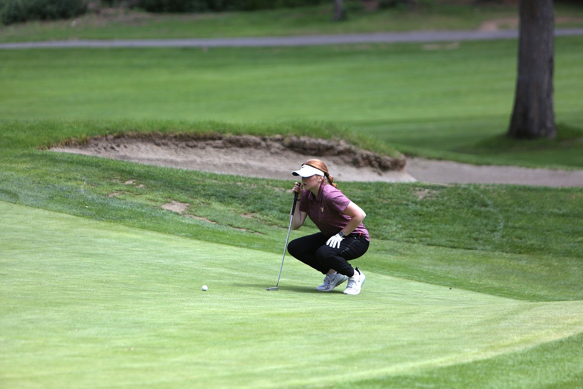 Moses Lake’s Rhylee Humphrey lines up a shot on the putting green at the Indian Canyon Golf Course in Spokane.