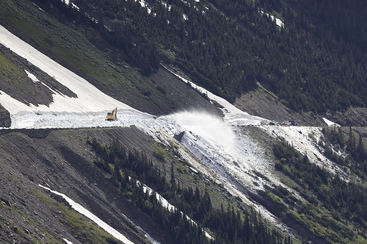 Plows send snow flying from the Going-to-the-Sun Road as they head up the east side toward the Big Drift in Glacier National Park on Tuesday, May 23. (JP Edge/Hungry Horse News)