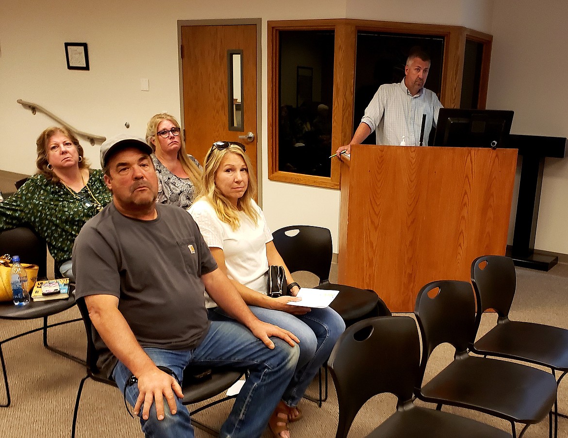 From left, owners of Bassett Construction Paige and Kellie Bassett, and Jeramie Terzulli of Olson Engineering submit a request for a zone change at a Hayden City Council meeting Tuesday.