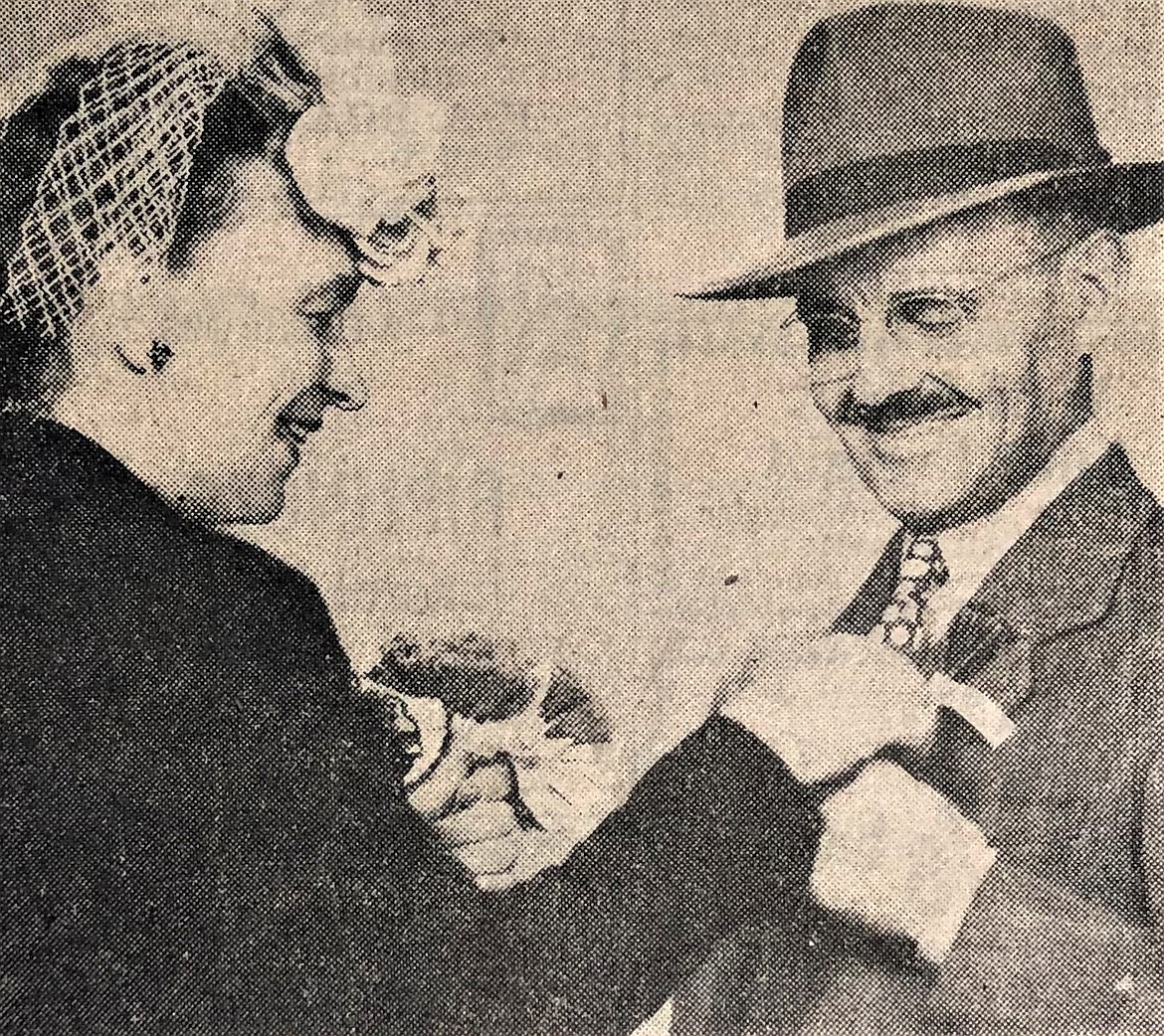 Mayor J.G. Adams buys the first poppy from Mrs. Claude Barnes.