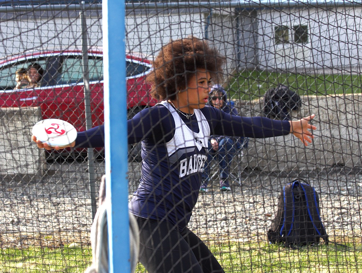 Asha Abubakari throws discus earlier in the season. Abubakari is named state champ for discus and shot put for the second year in a row.