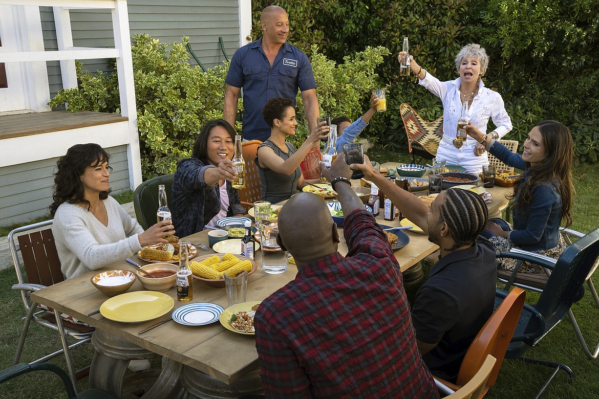 This image released by Universal Pictures shows, clockwise from left, Michelle Rodriguez, Sung Kang, Nathalie Emmanuel, Vin Diesel, Leo Abelo Perry, Rita Morena, Jordana Brewster, Ludacris and Tyrese Gibson in a scene from "Fast X."