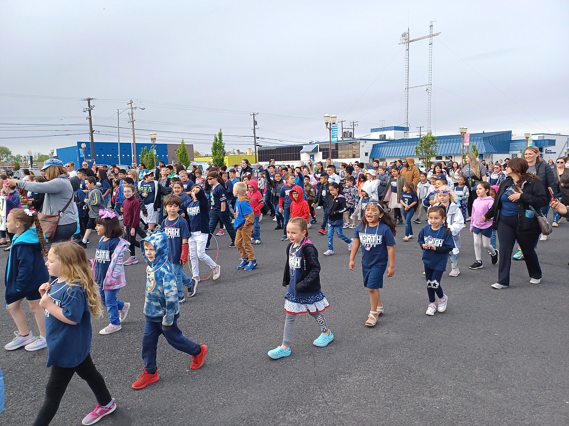 Students from North Elementary march down the street during the 2022 Spring Festival kiddie parade. Spring Festival 2023 is this weekend.