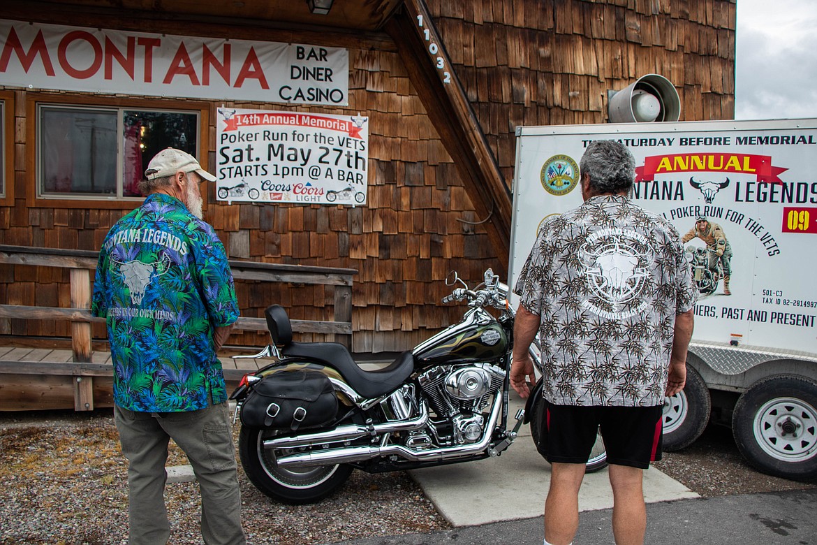 John "JP" Pettigrew, left, and Fella Mulberger, right, members of the Montana Legends, pose for a portrait at the A Bar in Ferndale in the week leading up to the 14th annual Montana Legends Poker Run for the Vets. The featured motorcycle is being auctioned off. (Kate Heston/Daily Inter Lake)
