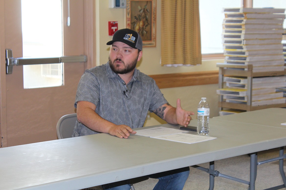 Quincy High School instructor Nick Heuker explains a project that would use wood from the existing Quincy Valley Medical Center site for a project in the new QVMC to the hospital board.