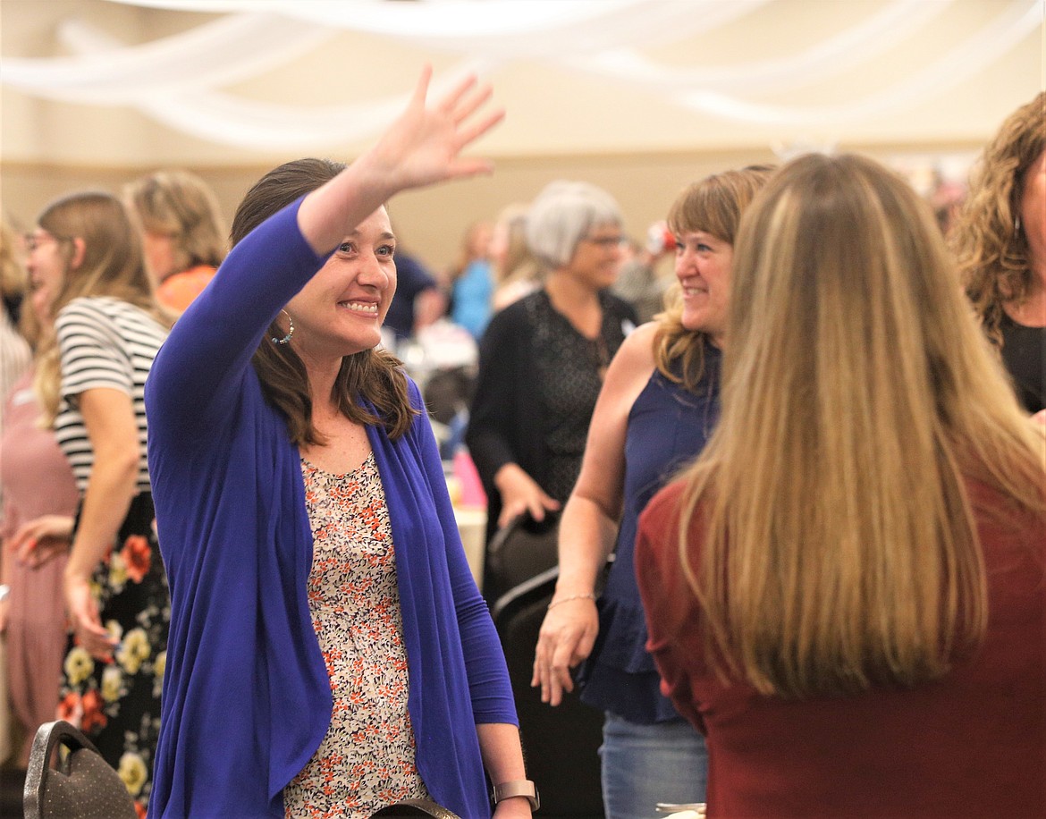 Amy Sweet waves during an exercise at the Women's Conference at the Best Western Plus Coeur d'Alene Inn on Wednesday.