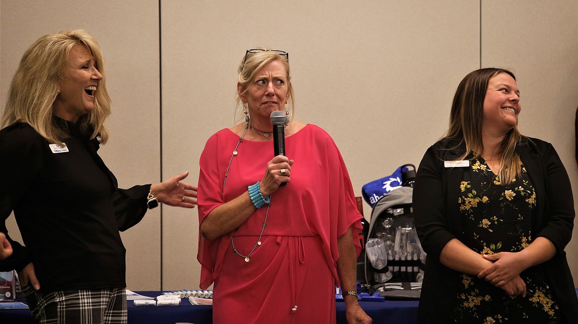 Marilee Wallace, CEO of The North Idaho Alliance, is joined by Tiffany Erbland, left, and Jen Magers, both with Idaho Trust Bank, during the Women's Conference on Wednesday.