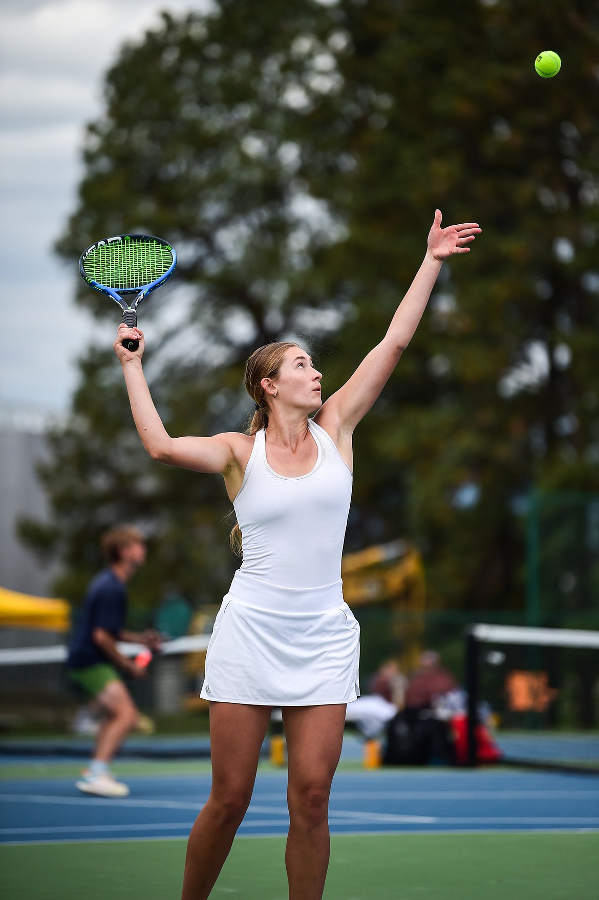 Glacier's Colette Daniels serves in a girls doubles match with teammate Katy Bitney against Sentinel's Hannah Kidd and Marin Meyer during the State AA tennis tournament at FVCC on Thursday, May 25. (Casey Kreider/Daily Inter Lake)