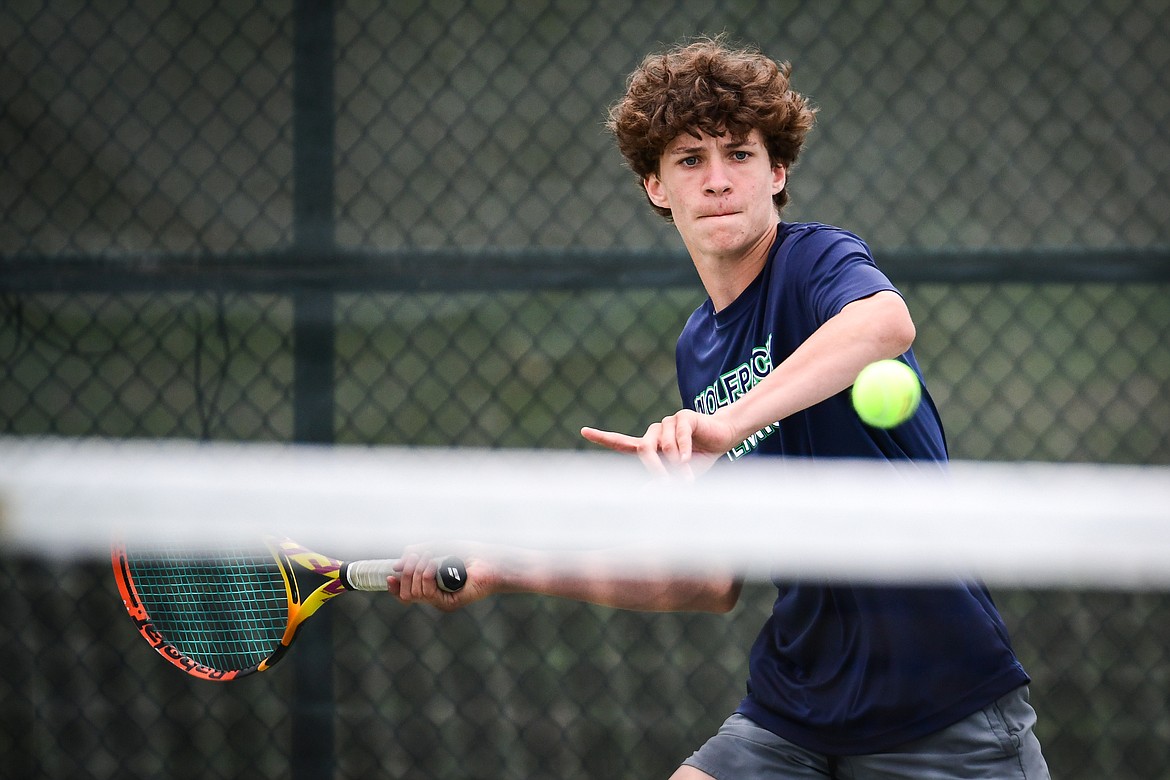 Glacier's Will Rudbach hits a return in a boys singles match against Gallatin's Mason McCarty during the State AA tennis tournament at FVCC on Thursday, May 25. (Casey Kreider/Daily Inter Lake)