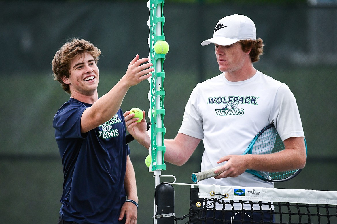 Glacier's Harrison Sanders and Timmy Glanville talk between sets against Hellgate's Manta O'Neill and Nikko Kujawa during the State AA tennis tournament at FVCC on Thursday, May 25. (Casey Kreider/Daily Inter Lake)